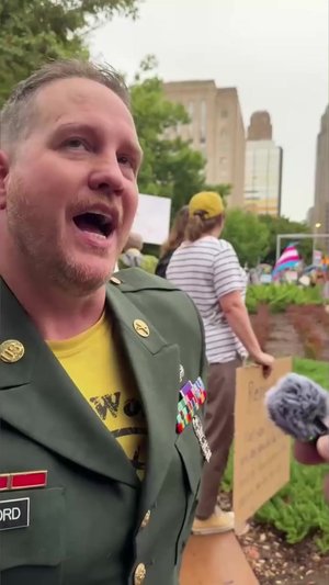 U.S. Army veteran Brian Wofford, who was wounded while serving in Iraq, attended the rally in his gr...